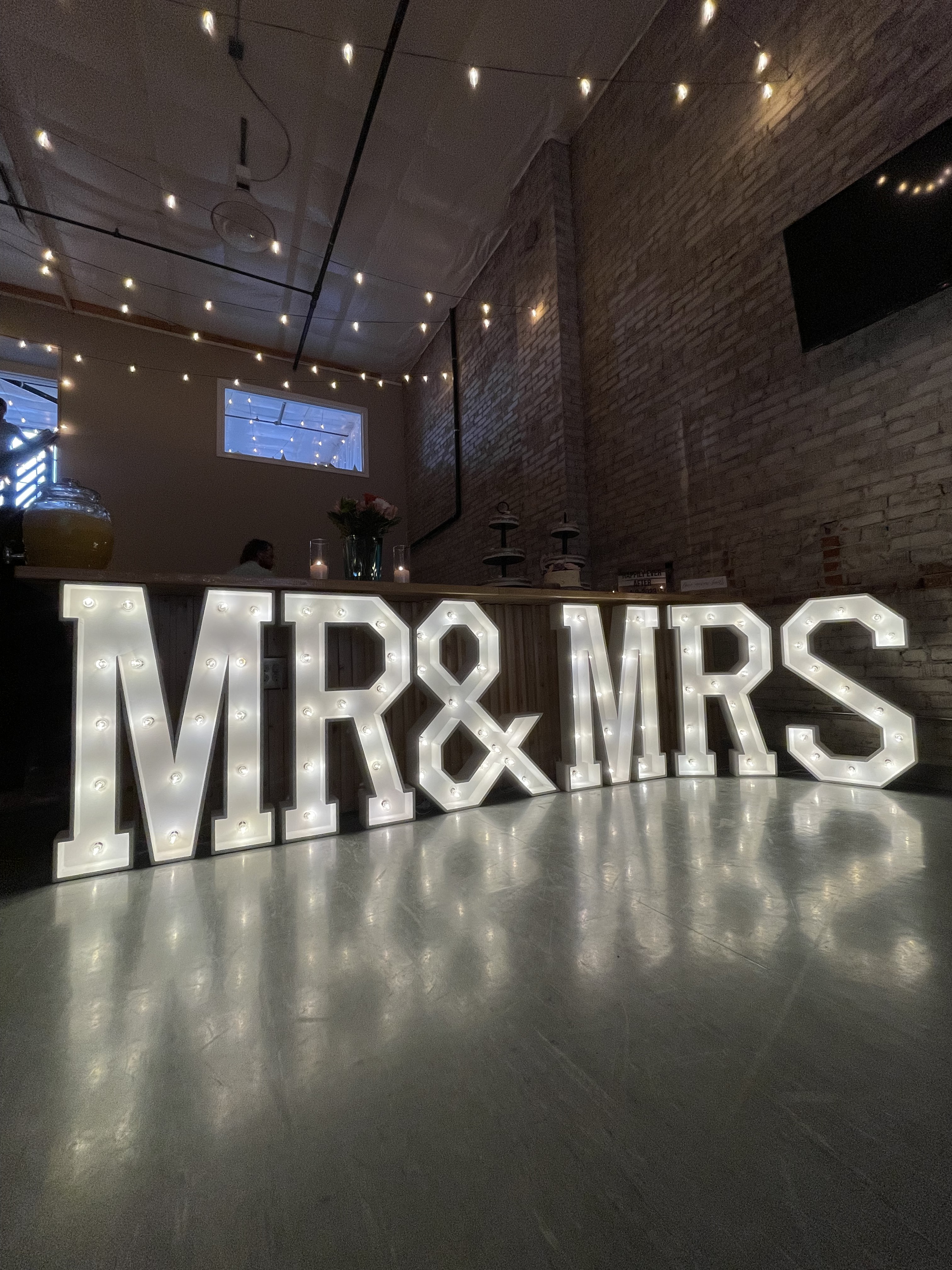 Light-up MR & MRS marquee letters on the dance floor under string lights at Host Wenatchee