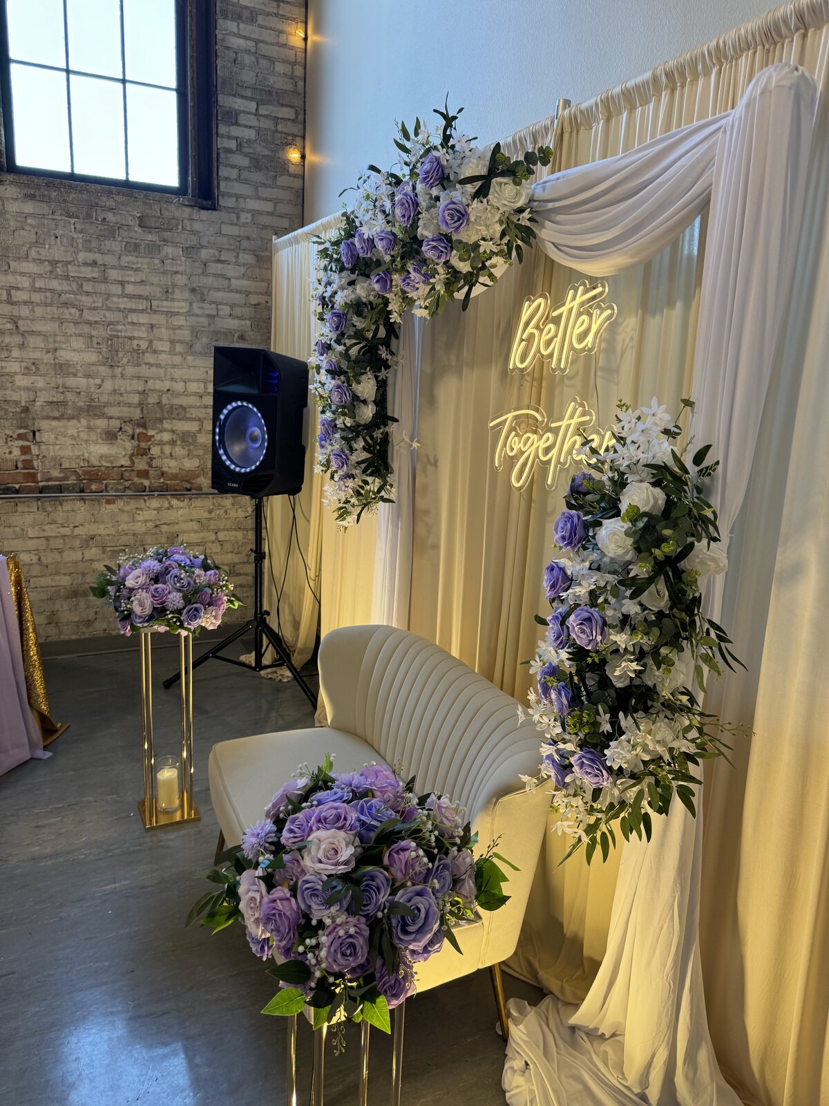 Soft draping, lavender and white florals framing a memory display at Host Wenatchee