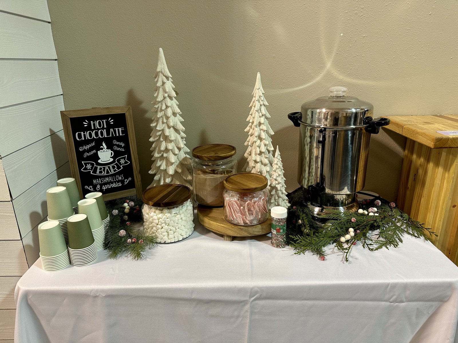 Hot chocolate bar with marshmallows, candy canes and flocked trees at a Wenatchee holiday party