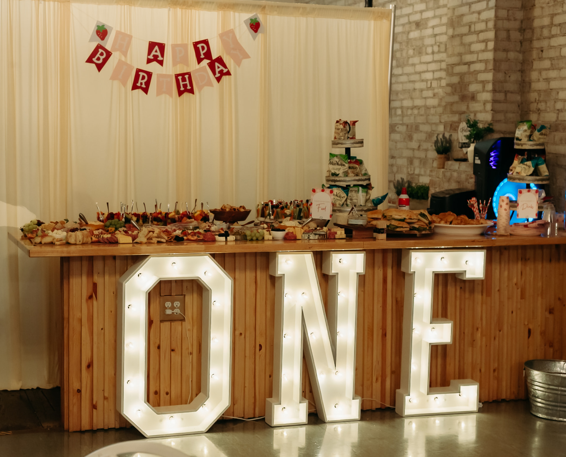 Light-up marquee letters and a food bar along the wood counter at Host Wenatchee
