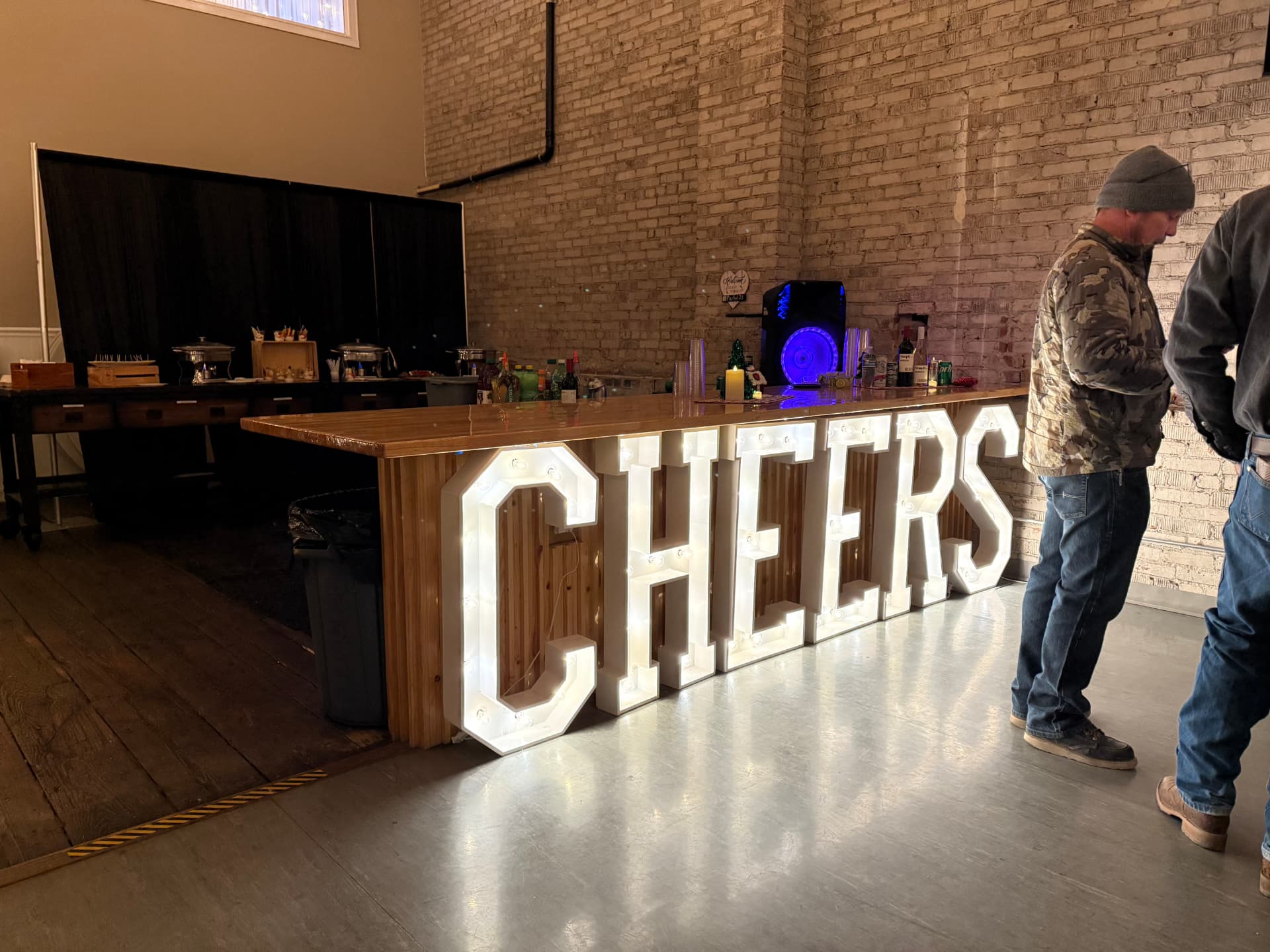 Wood bar with light-up CHEERS marquee letters and holiday drinks at a Christmas party at Host Wenatchee