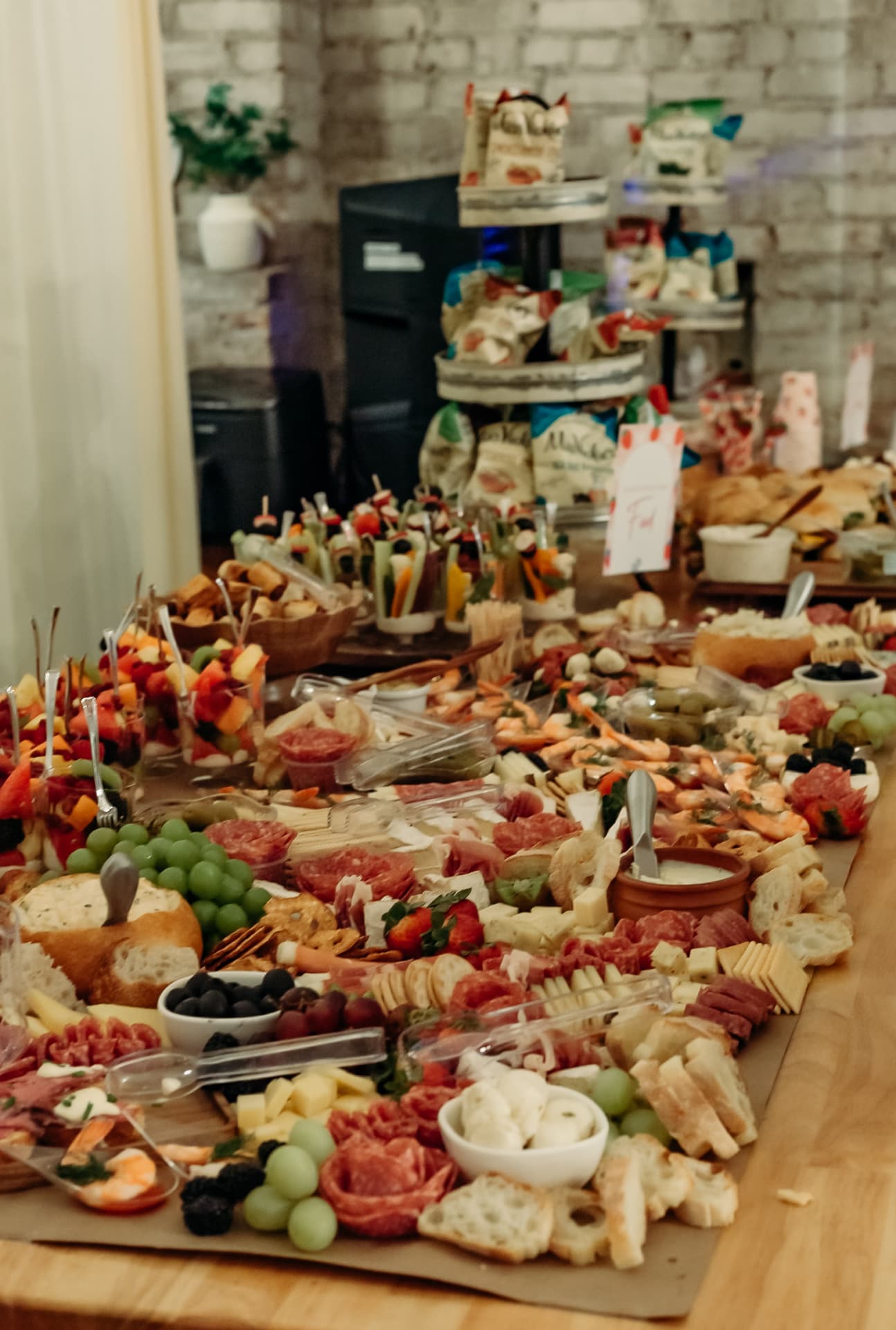 Long grazing table of meats, cheeses and fruit at a Wenatchee event
