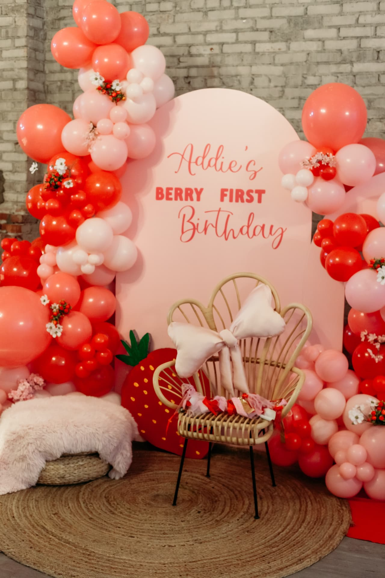 First birthday party with balloon arch and strawberry backdrop at Host Wenatchee