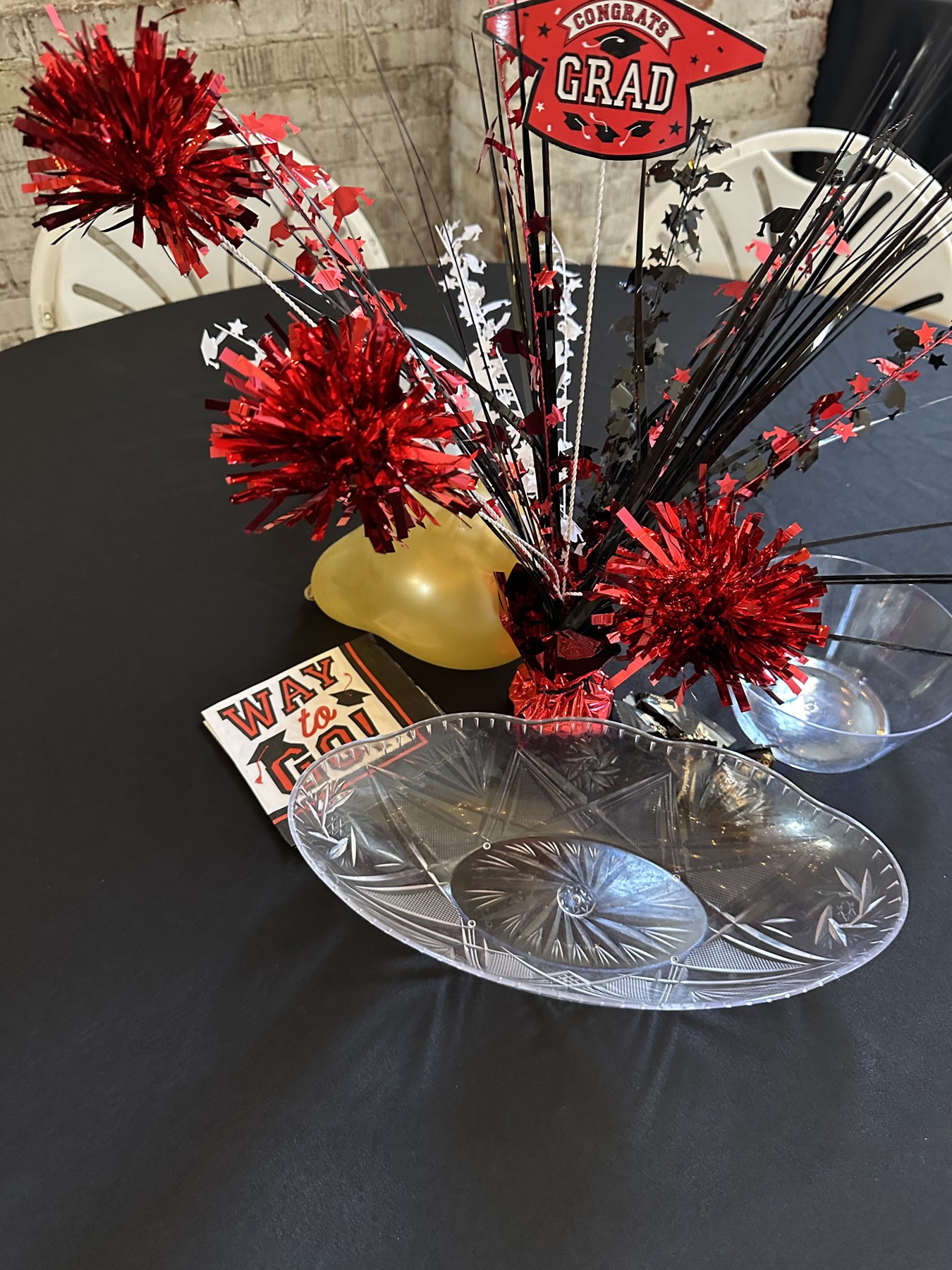 Red and black Congrats Grad table centerpiece on a round table at a graduation party at Host Wenatchee