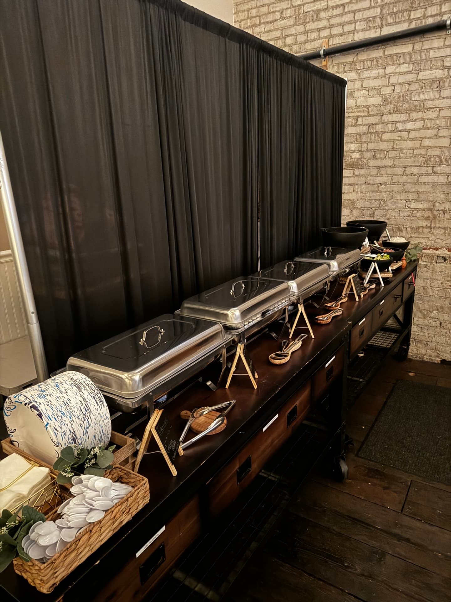 Chafing dishes, plates and serving utensils set for a catered holiday party buffet at Host Wenatchee