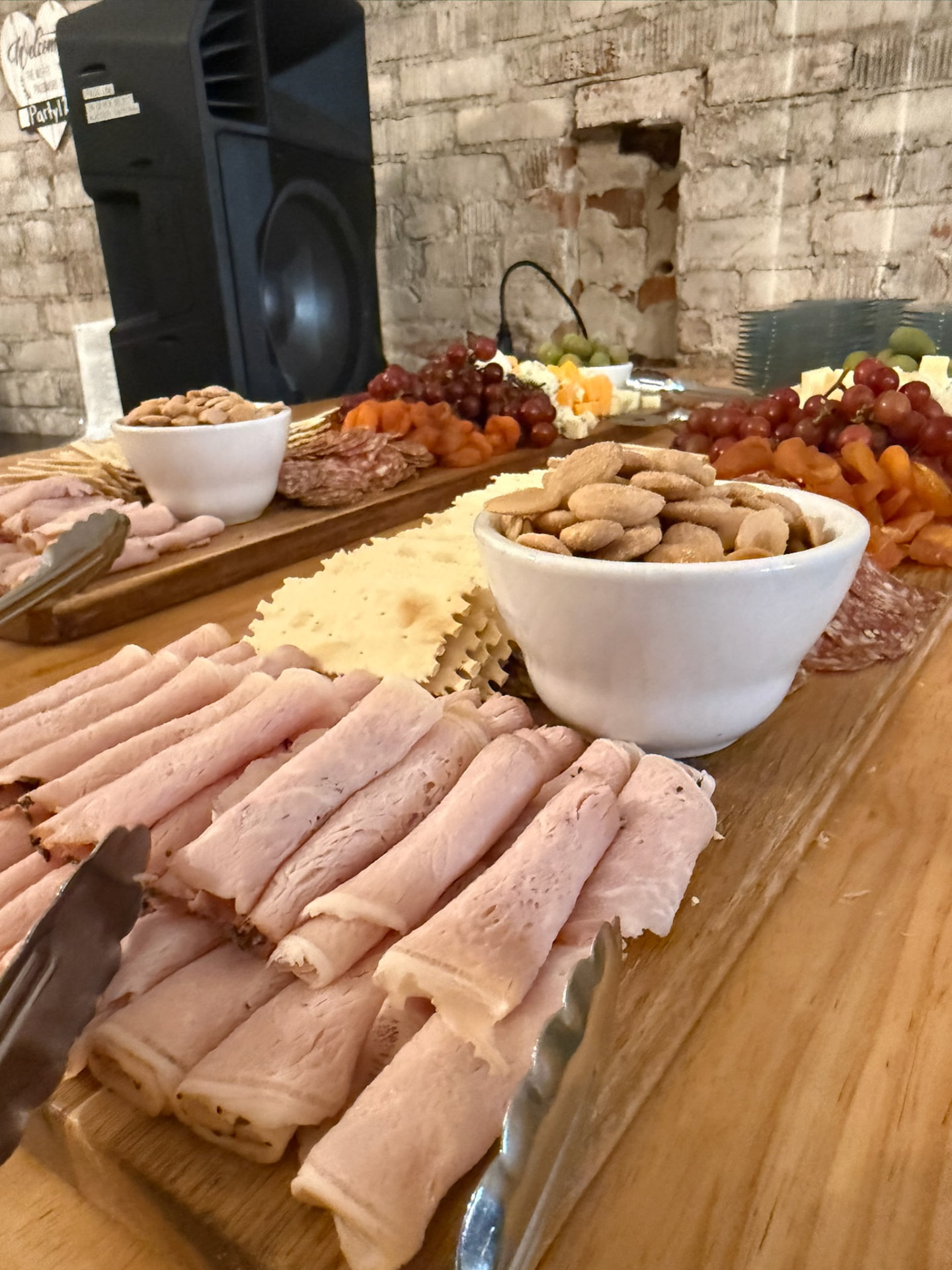 Charcuterie and grazing boards with sliced meats, cheese, grapes and nuts at a corporate event in Wenatchee
