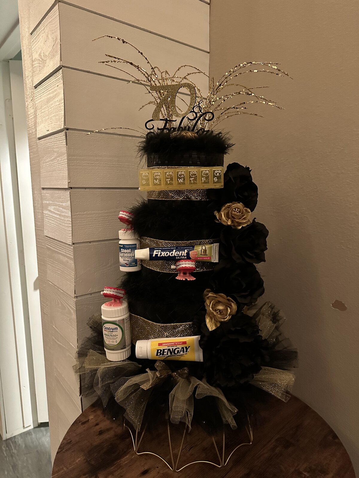 Black and gold 70 and Fabulous gag gift cake tower at a 70th birthday party at Host Wenatchee