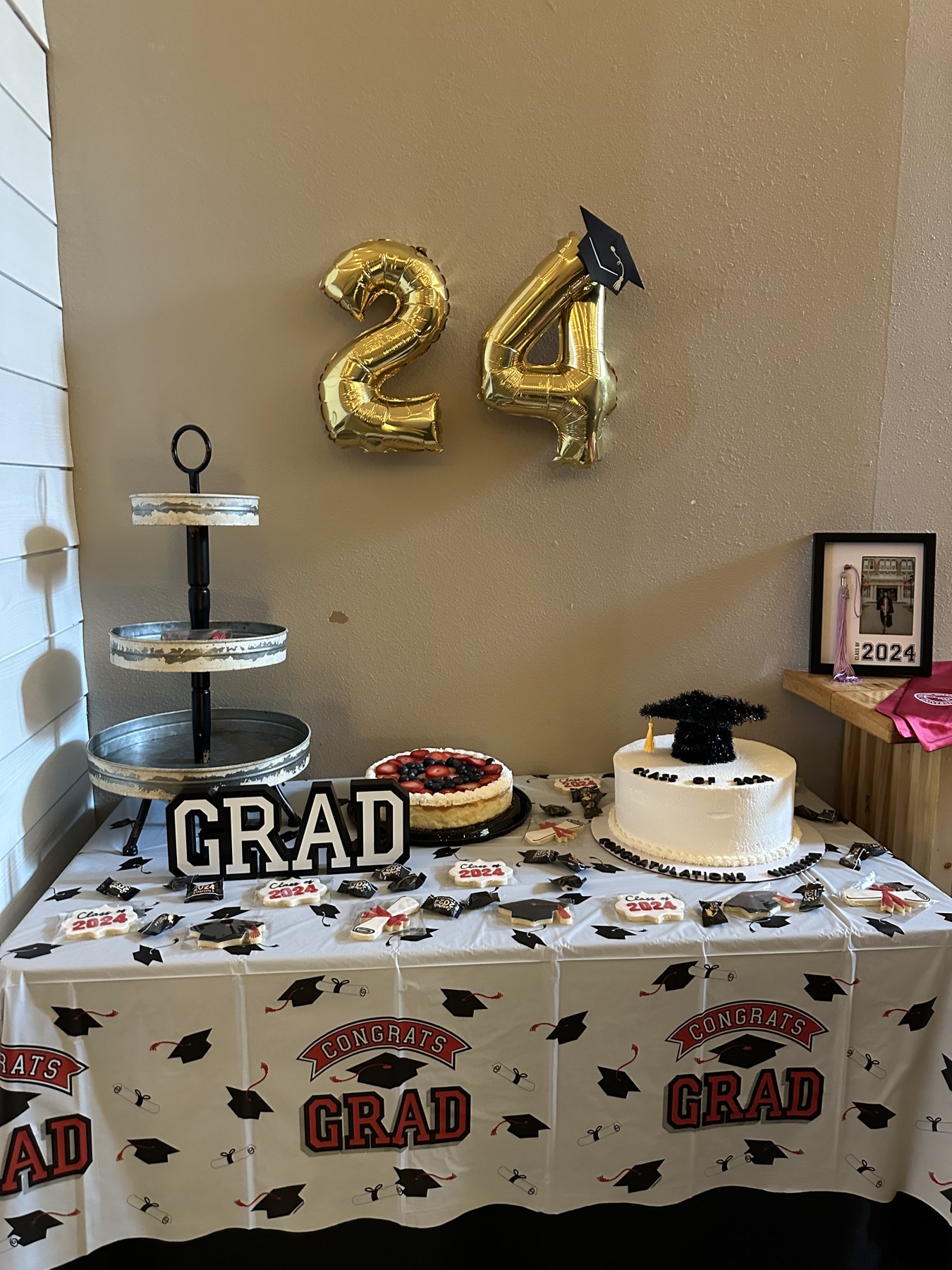 Graduation dessert table with cheesecake, class-of-2024 cookies and gold 24 balloons at a grad party at Host Wenatchee