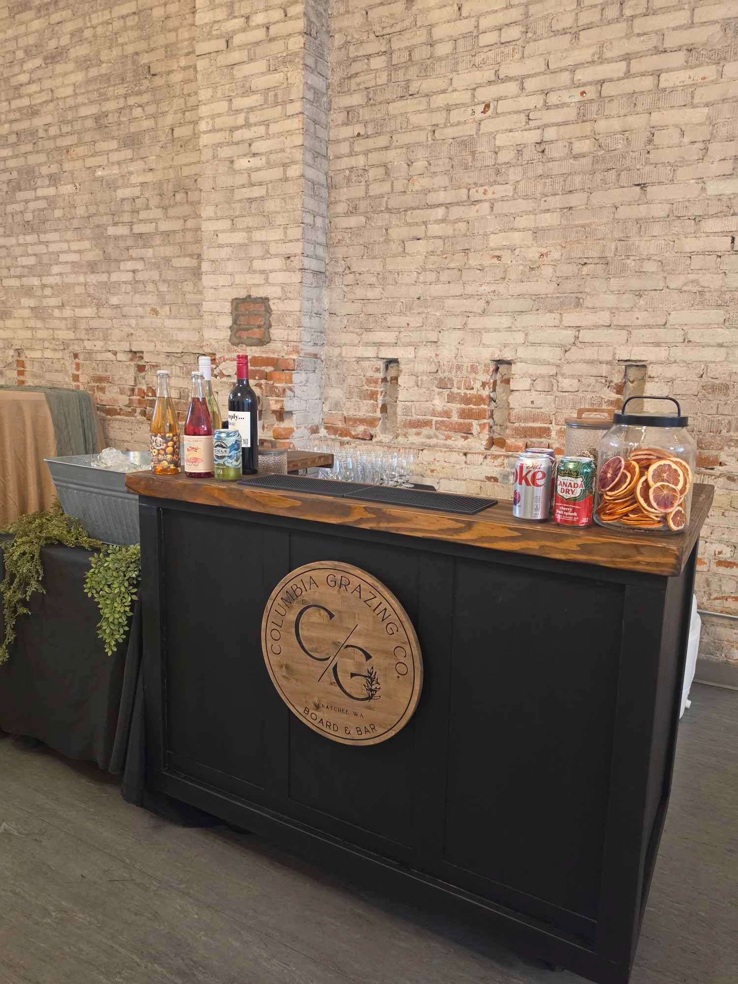 Columbia Grazing Co. board and bar set with wine, sodas and dried citrus at a corporate event at Host Wenatchee
