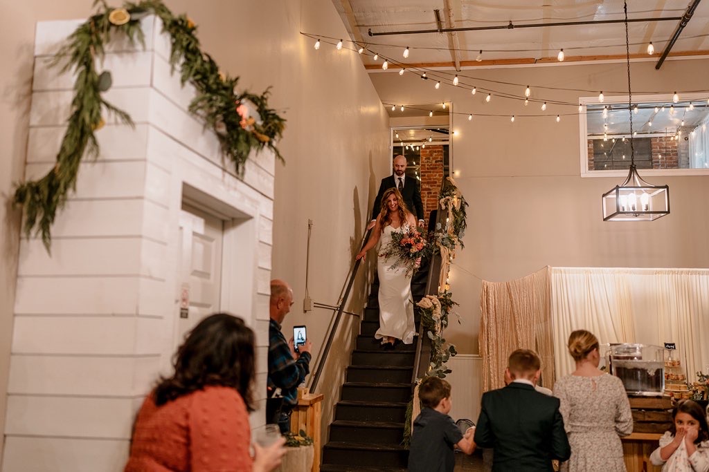 Bride and groom entering the reception down the garland staircase at Host Wenatchee