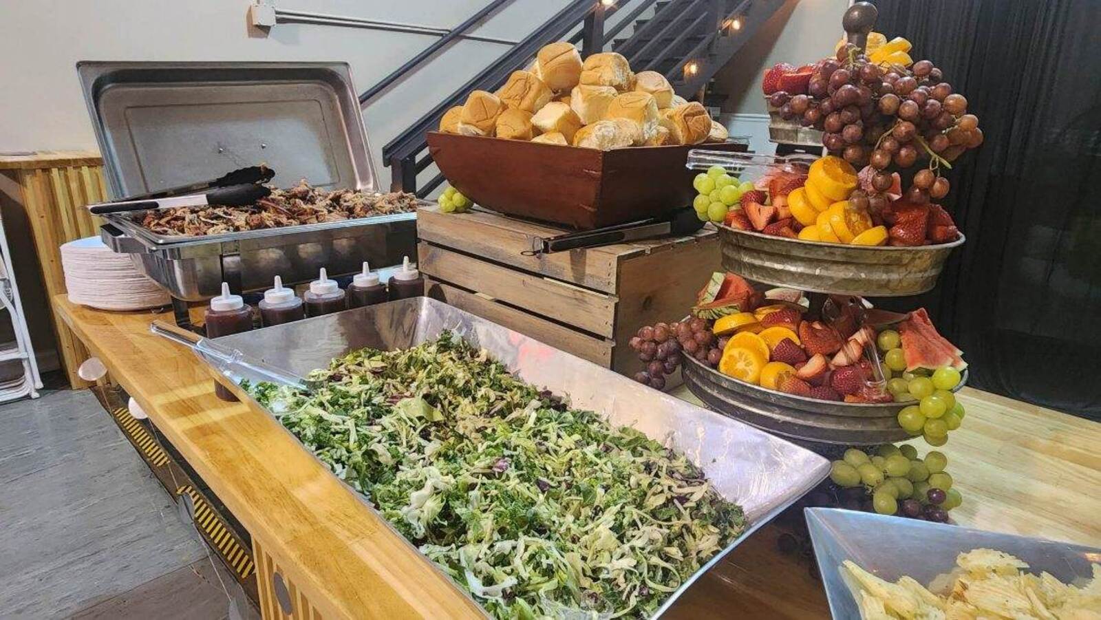 Catered buffet with pulled pork, salad, rolls and tiered fresh fruit at a corporate event in Wenatchee