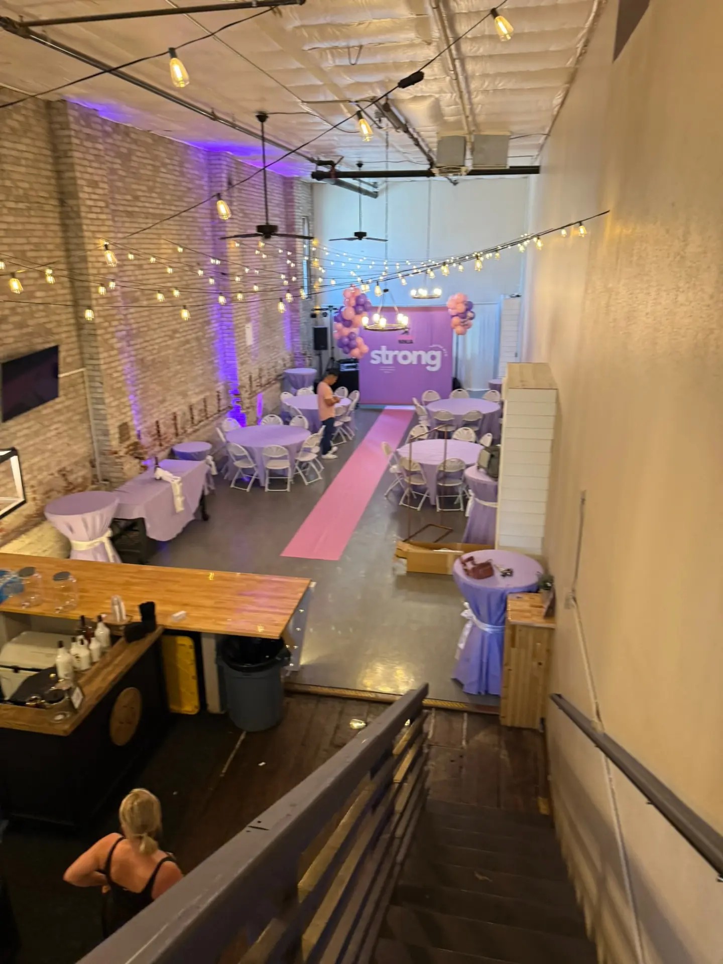 Birthday party setup with purple uplighting, pink carpet and a custom strong backdrop at Host Wenatchee
